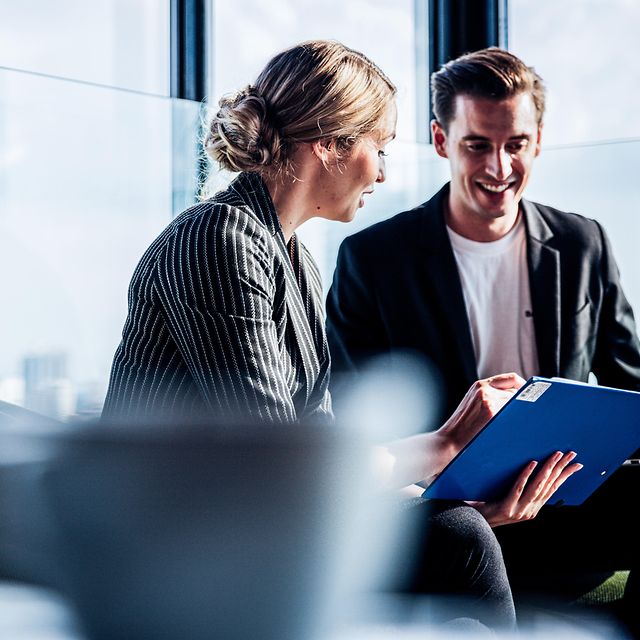 Gruppe von zwei Geschäftsleuten besprechen die Vorteile von Microsoft Premium Services.